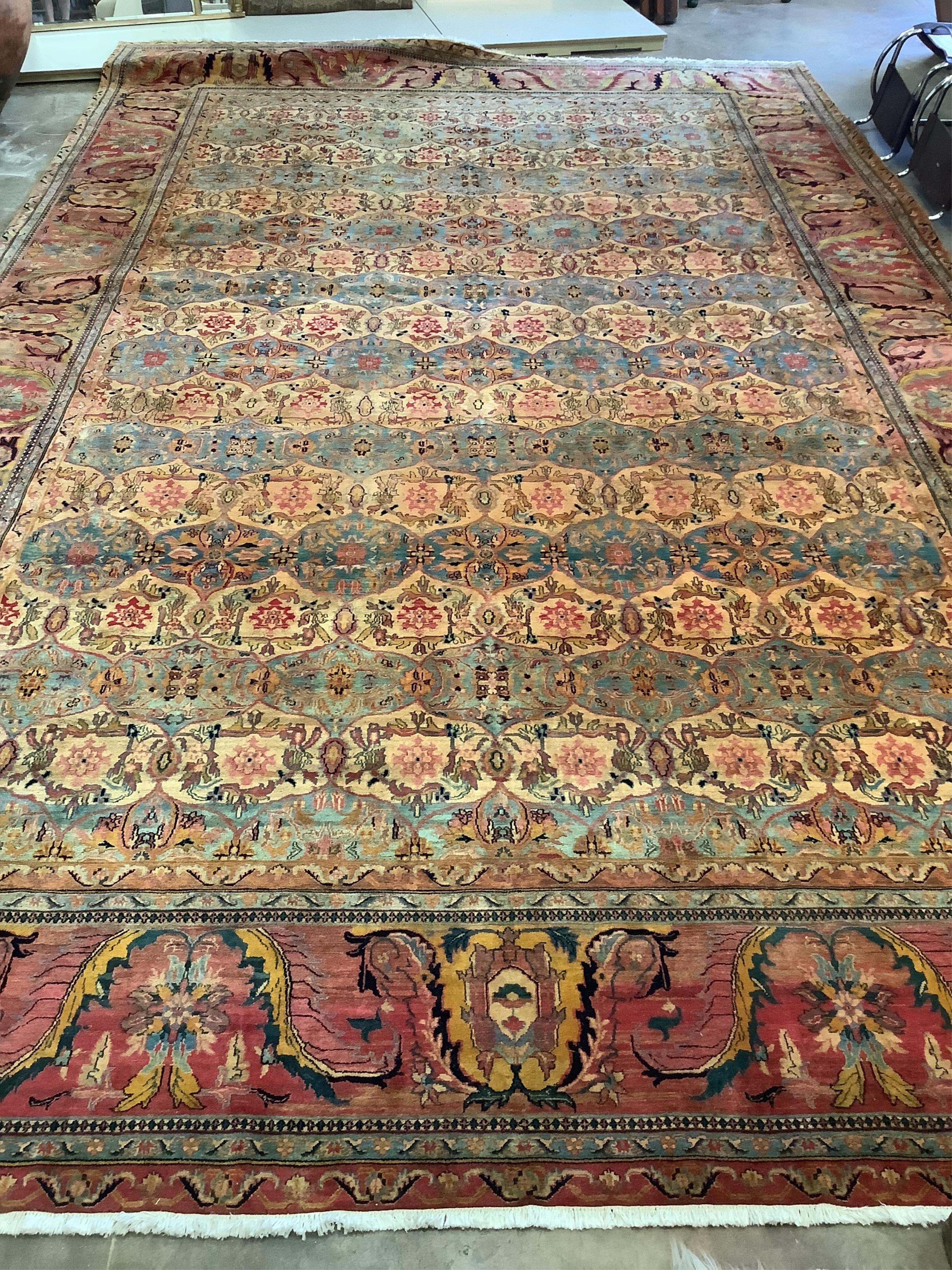 A large Persian design ivory ground carpet, 590 x 365cm. Condition - good
